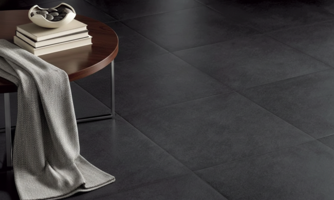 Elegant interior setting featuring matte black porcelain tile flooring with a wooden side table.