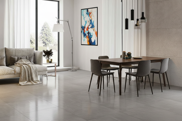 Contemporary open-concept living space featuring polished grey porcelain tile flooring and a wooden dining set.