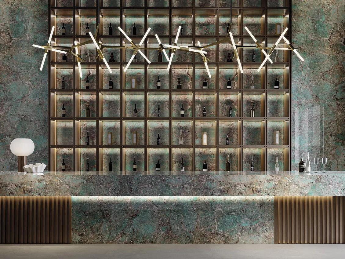 Modern bar counter with Santos porcelain slabs creating stunning backdrop for commercial space.