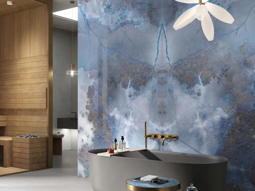 Modern bathroom featuring Thunderstorm porcelain slabs wall with white freestanding tub and pendant light.