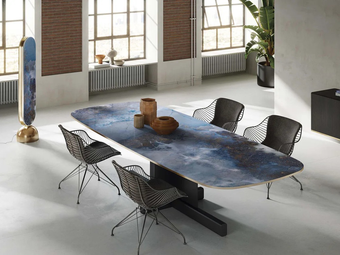 Large format Thunderstorm porcelain slabs showcased as contemporary dining table surface design.