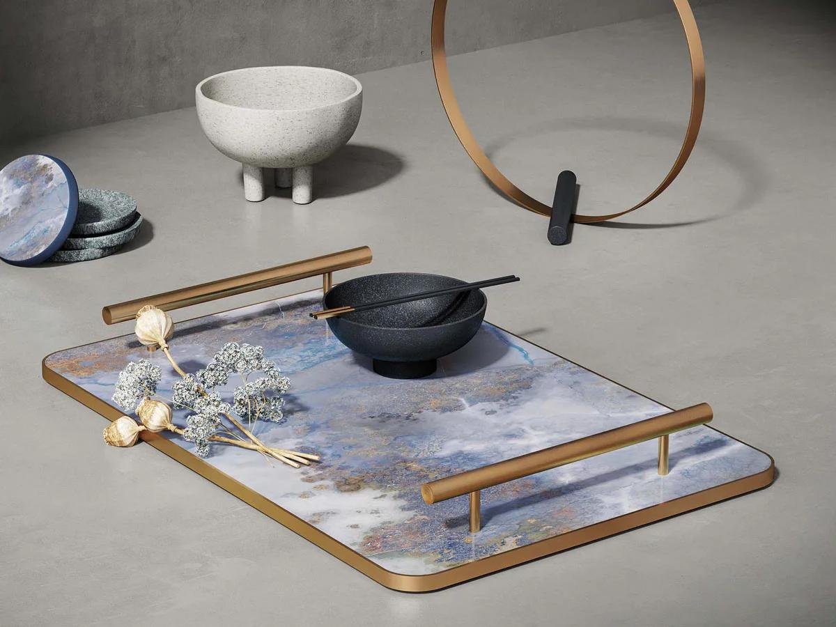 Decorative tray made from Thunderstorm porcelain slabs with brass frame on concrete kitchen counter.