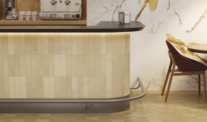 Contemporary kitchen with cream porcelain tiles and gold marble wall