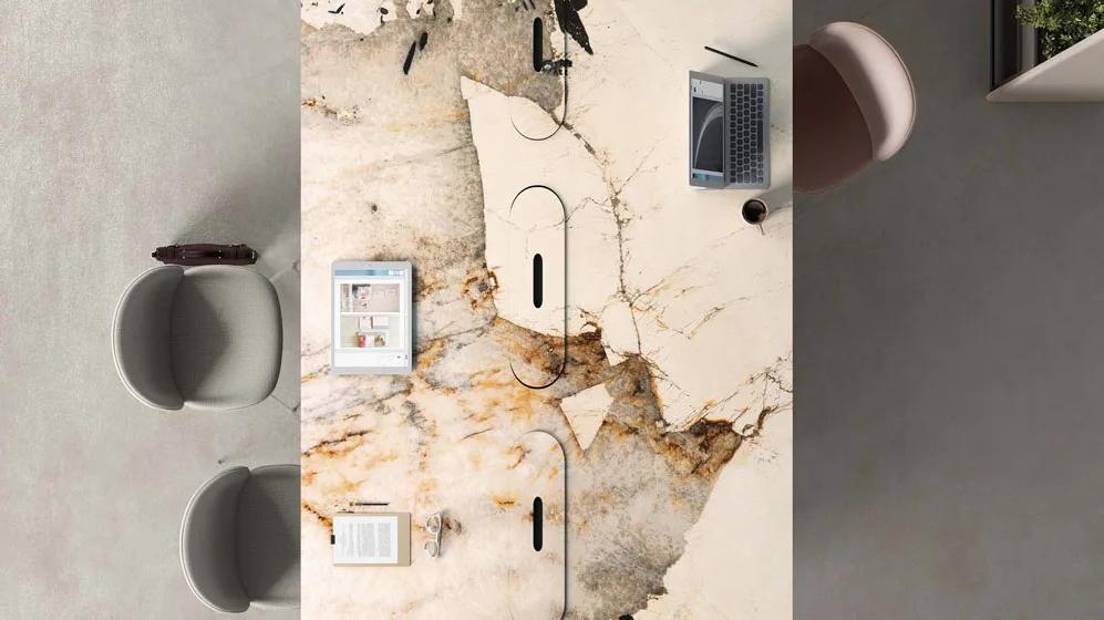 Elegant desk featuring Magellano porcelain slabs with cream and gold organic patterns.