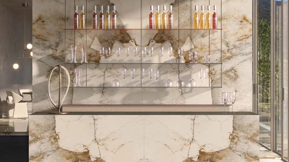 Sophisticated bar area with backlit Magellano porcelain slabs and glass shelving.