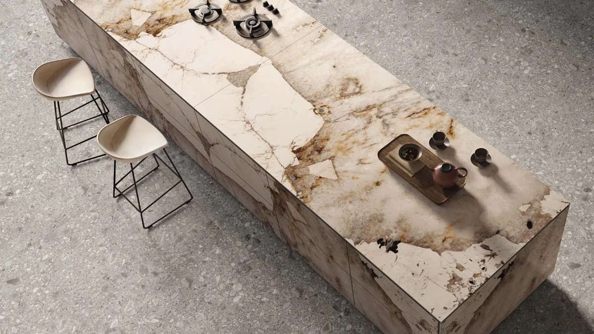 Luxury dining table featuring large format Magellano porcelain slabs with dramatic veining.