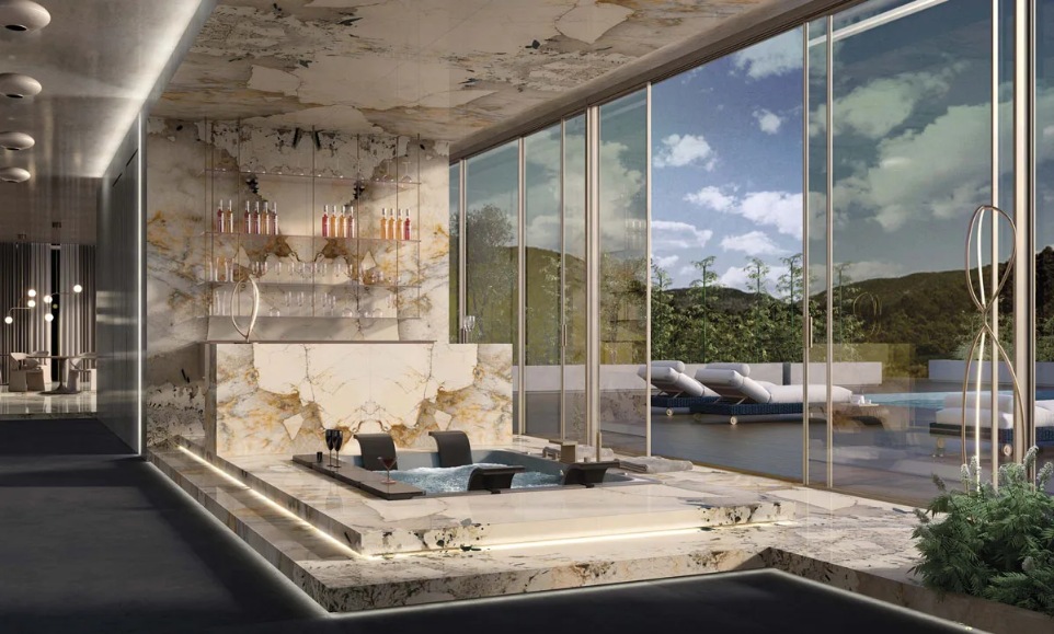 Stunning living room with floor-to-ceiling Magellano porcelain slabs and pool views.