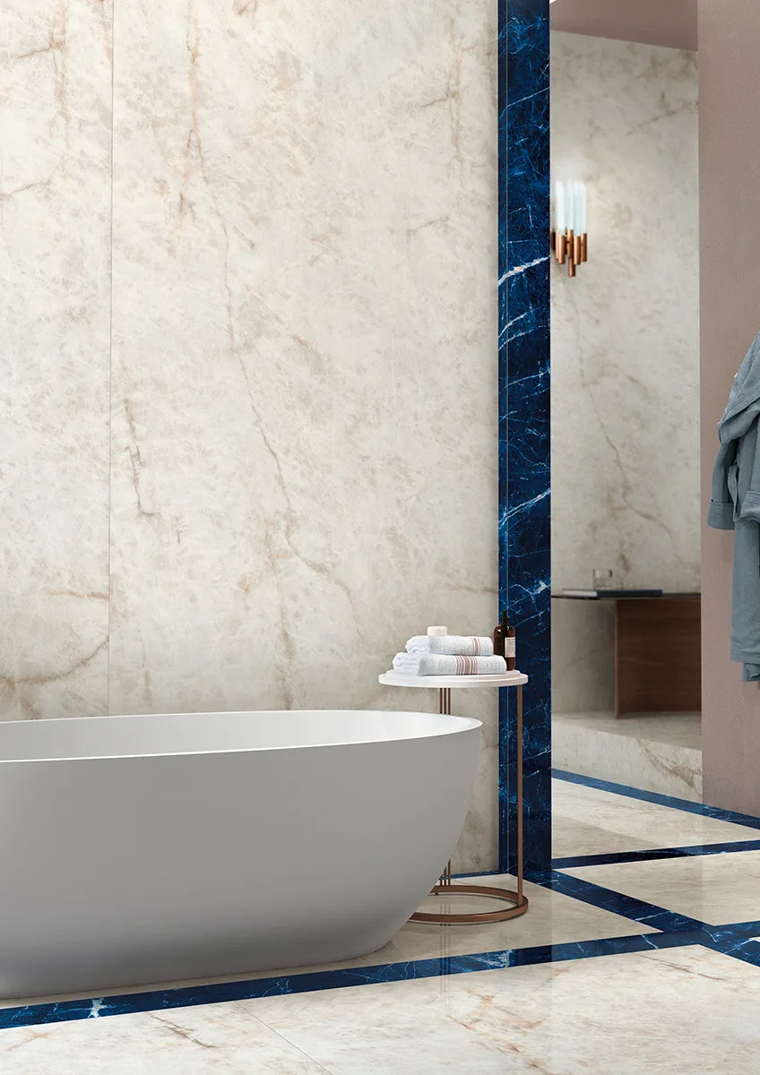 Crystal Ice porcelain slabs as wall cladding in modern bathroom with freestanding tub.