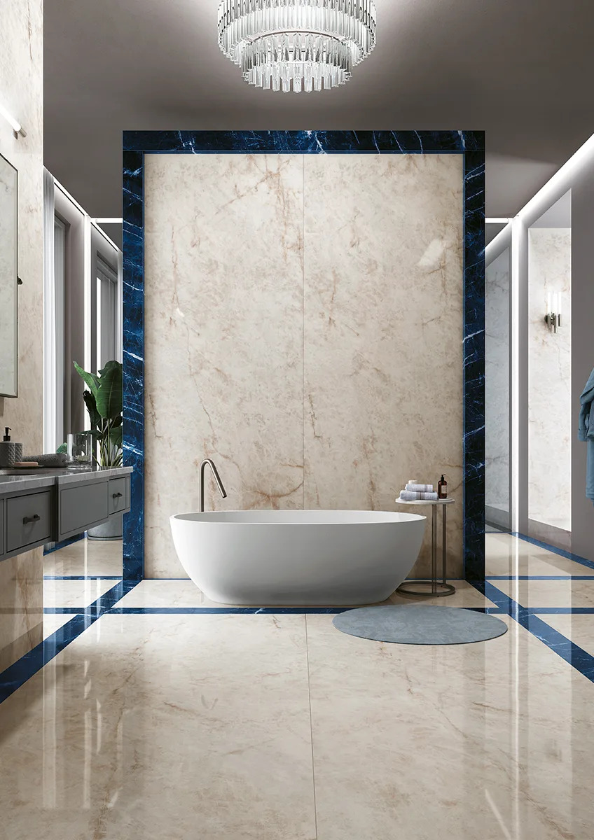 Crystal Ice porcelain slabs used on bathroom walls and floors with elegant white bathtub.