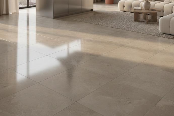 Close up of greige porcelain tile surface showing polished finish texture.