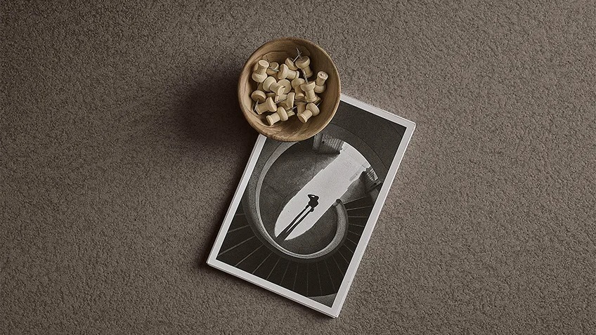 Plaster Warm porcelain slabs displaying gray plaster texture with decorative bowl and photograph.