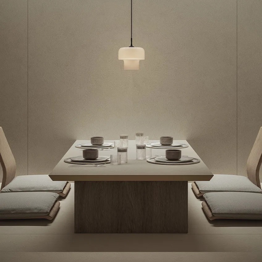 Contemporary dining room showcasing Plaster Ground porcelain slabs on table and coordinated flooring.
