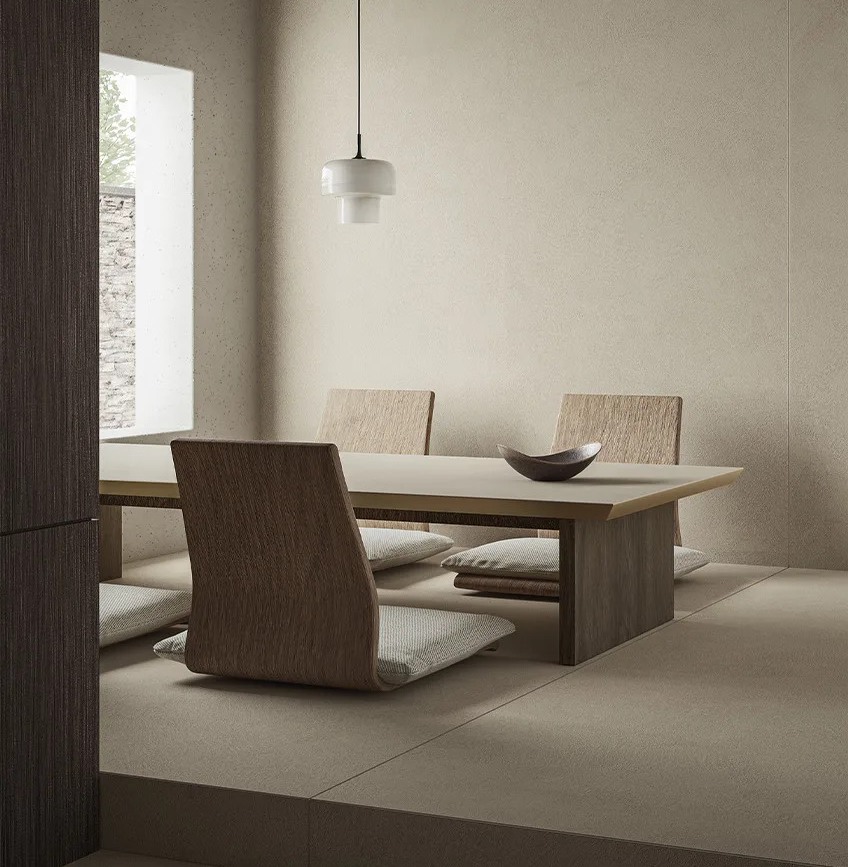 Plaster Ground porcelain slabs creating cohesive walls and floors in modern neutral interior.