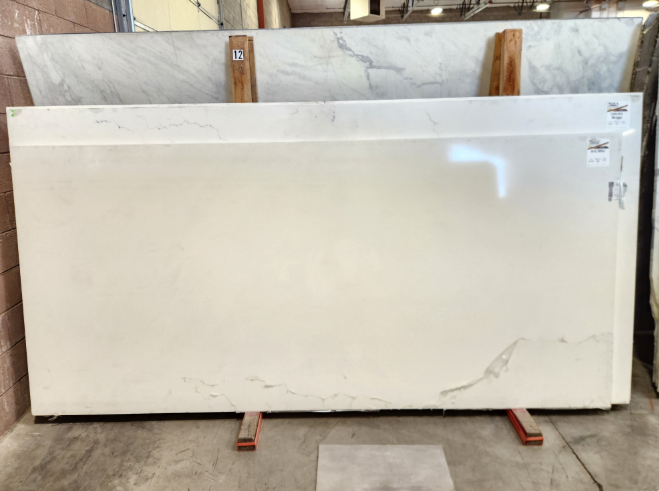 Arctic White slab with subtle gray veining in Nova Tile and Stone showroom inventory