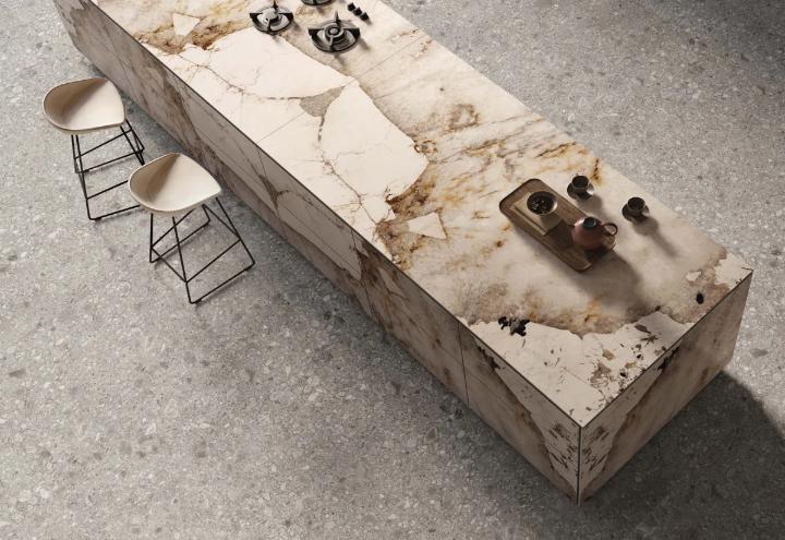 Modern luxury kitchen island with a waterfall edge design using polished stone slabs