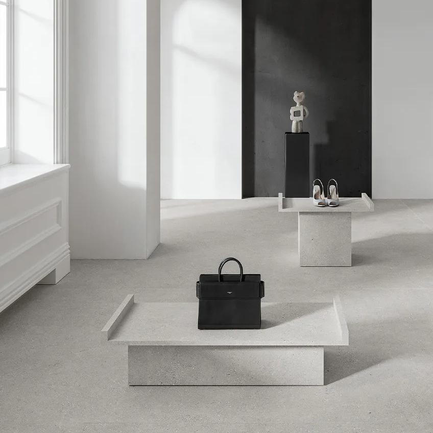 Modern retail display with Sandstone Light porcelain slabs used as countertop surface and backdrop.