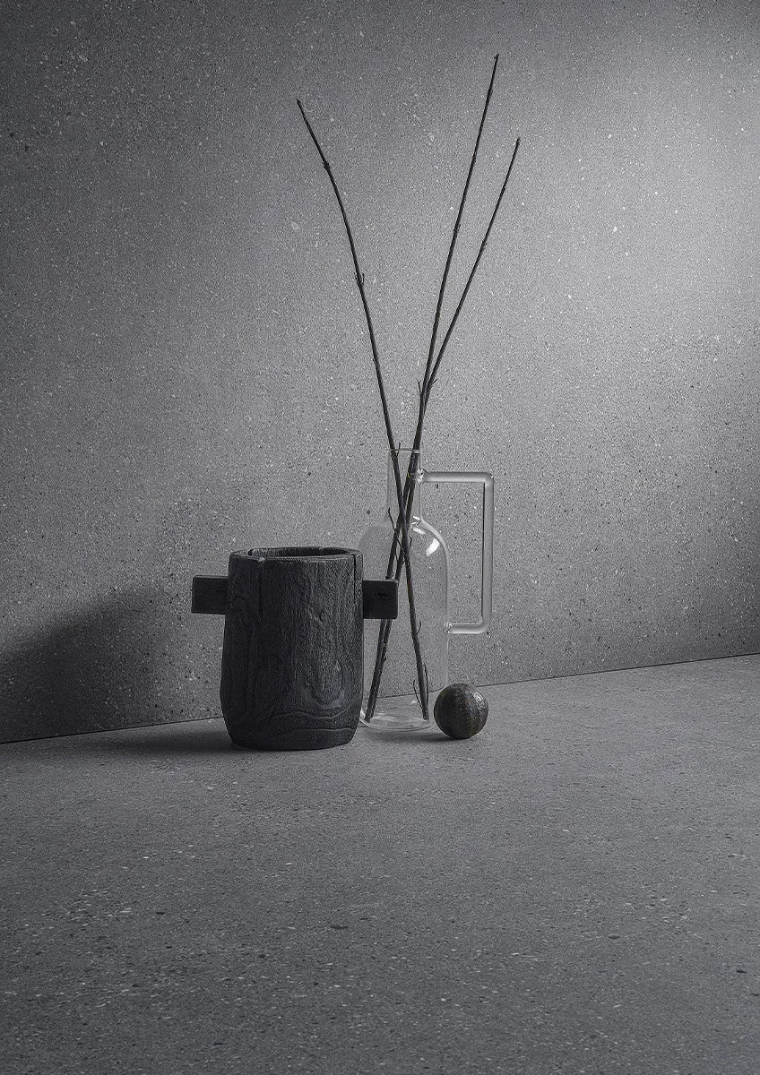 Sandstone Gray porcelain slabs wall application with minimalist decor and decorative vase.