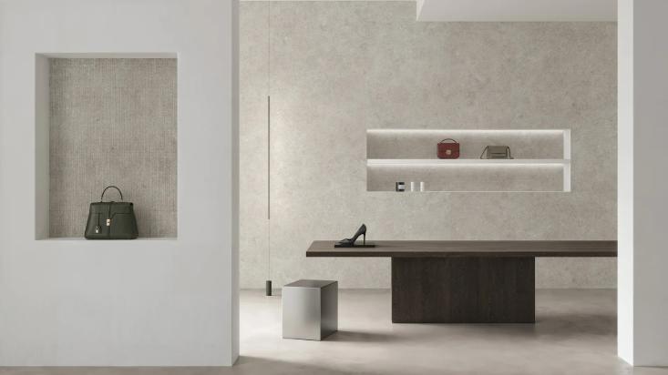 Fossil Row porcelain slabs on walls and floors of a modern luxury retail space.