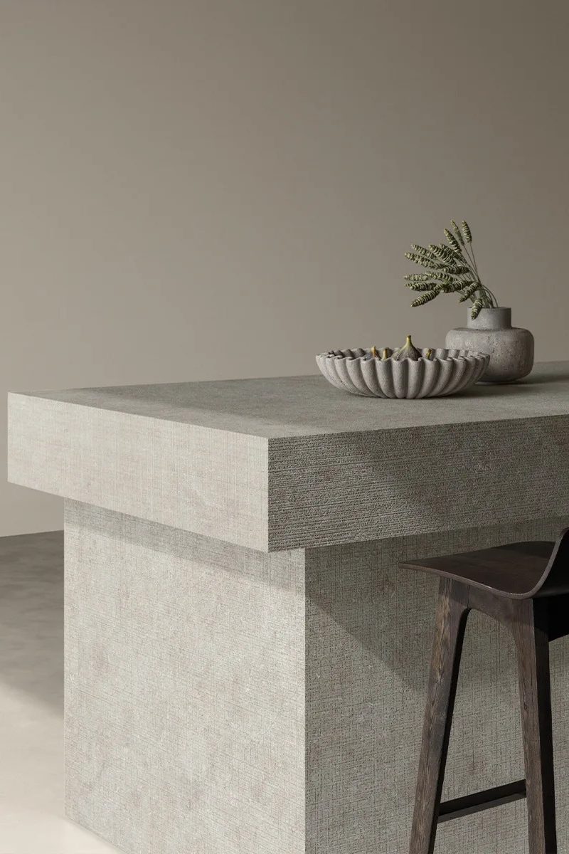 Fossil Tartan porcelain slabs as a kitchen island countertop with a wooden bar stool