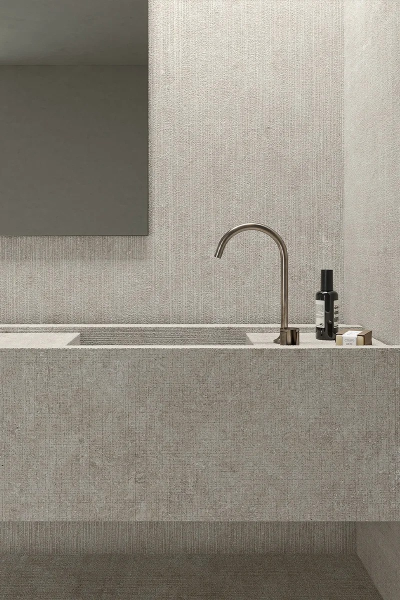 Bathroom sink area featuring Fossil Tartan porcelain slabs on the countertop and wall surface