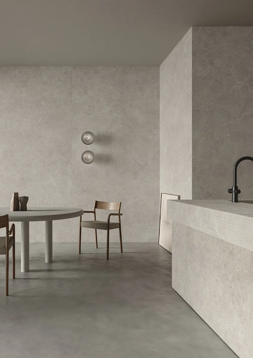 Modern kitchen and dining area showcasing Fossil porcelain slabs on floors and walls.
