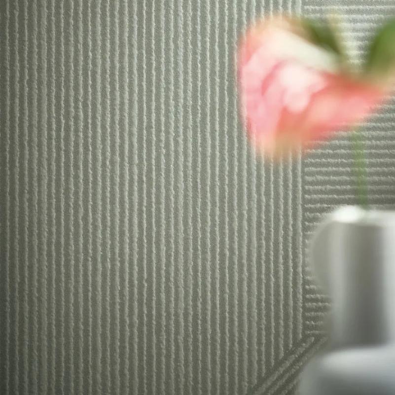 Modern interior featuring Ginza Midori porcelain slabs with pink tulip and minimalist sage-green textured wall.