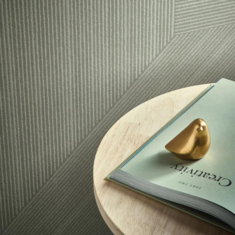 Sage-green Ginza Midori porcelain slabs featuring tabletop styling with gold decor and magazine on plate.