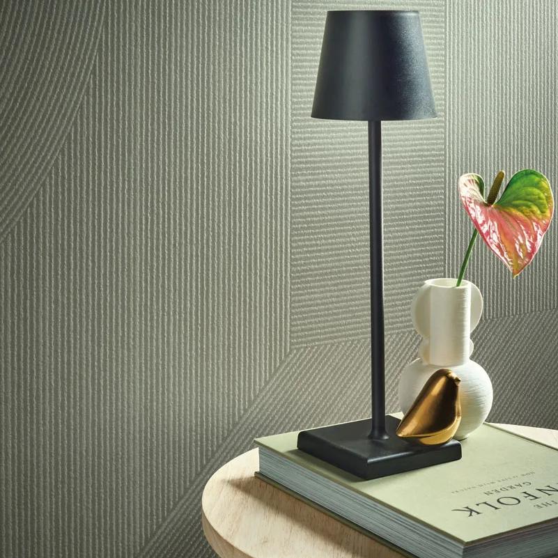 Ginza Midori porcelain slabs feature wall with black floor lamp, glass vase, and pink flower arrangement.