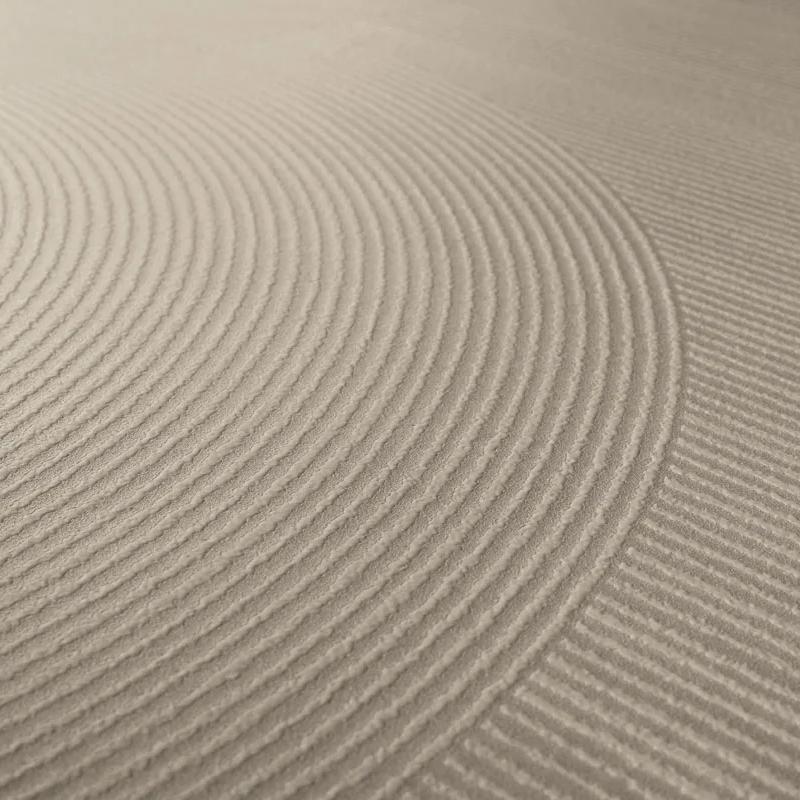 Close-up view of Ginza Doro porcelain slabs showing three-dimensional sculpted sand geometric texture.