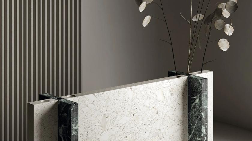 Modern design featuring Terrazzo White porcelain slabs countertop with decorative black marble and plants.