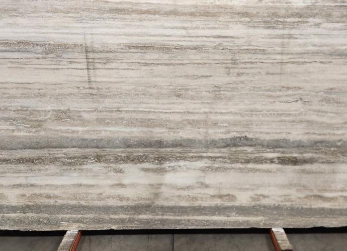 Italian silver veincut travertine slab at Nova Tile and Stone showroom