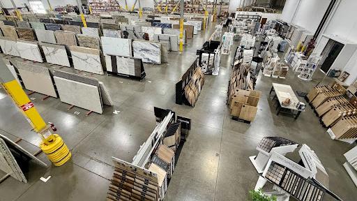 Large Nova Tile and Stone facility showcasing thousands of porcelain slab displays in spacious warehouse showroom.