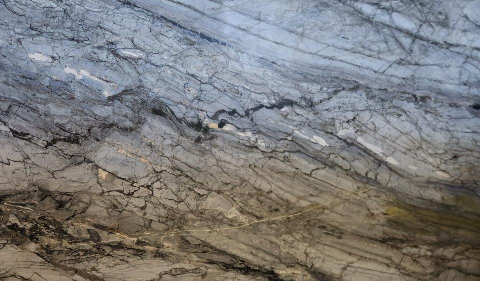 Natural stone slab with blue-gray and taupe tones with fine black veining