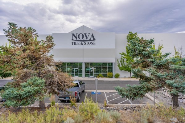 Exterior view of Nova Tile and Stone building featuring modern architecture and professional landscaping.