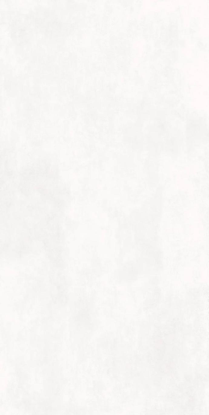 Total White porcelain slabs with a soft organic look and minimalist all-white surface finish.