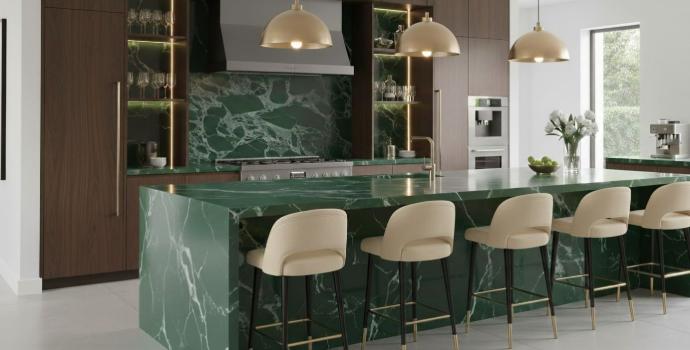 Green marble countertop and backsplash in a modern luxury kitchen with gold pendant lights