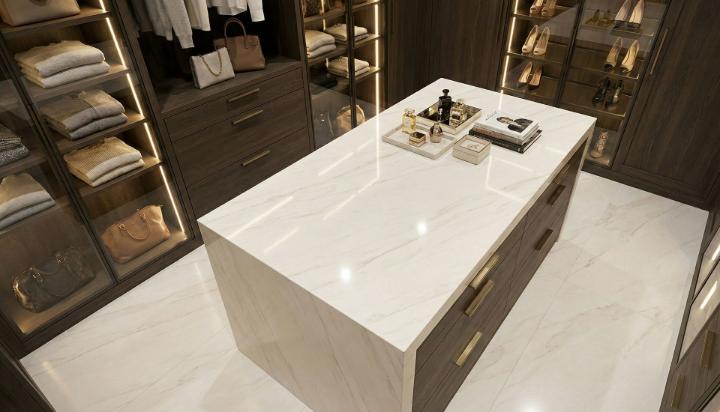 White marble-look porcelain slab countertop and flooring in a luxury walk-in closet