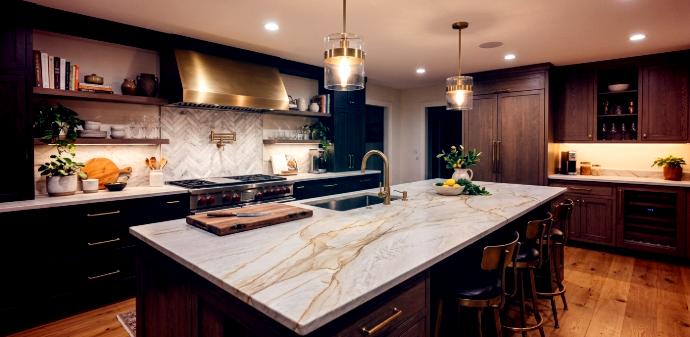 Kitchen island with warm white stone and gold veining. Taj Mahal Quartzite