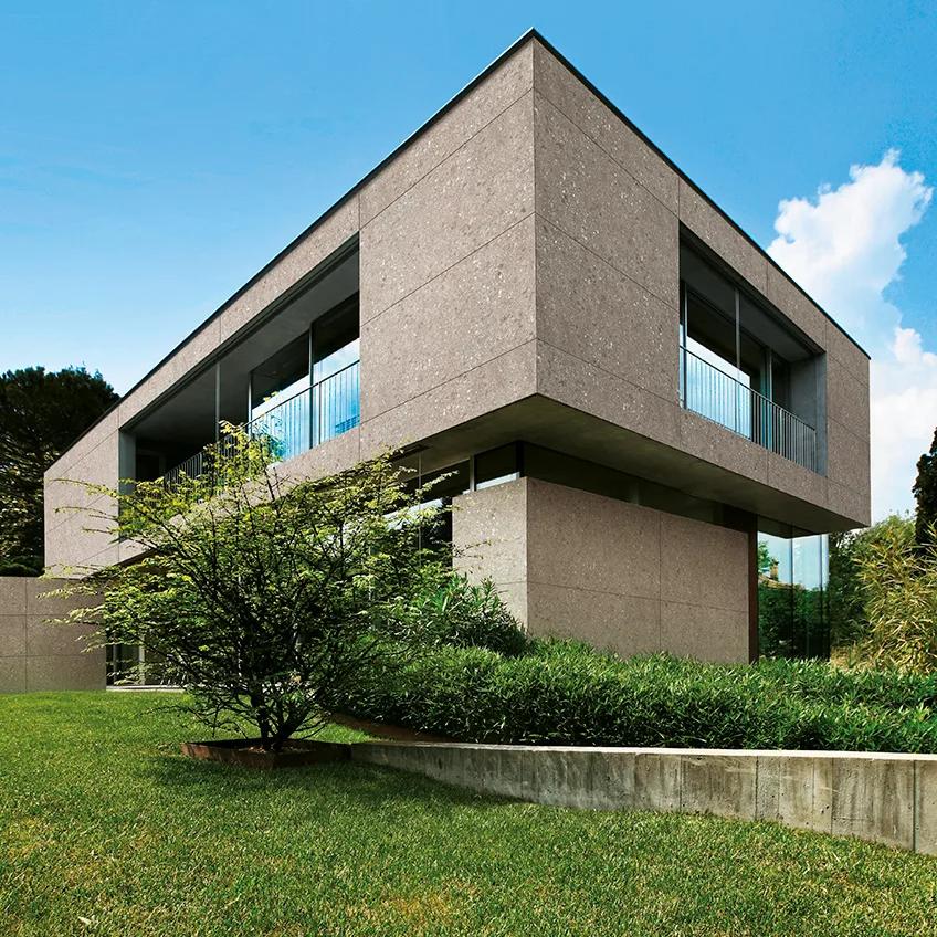 Modern concrete house exterior featuring Milan Stone porcelain slabs and minimalist architecture