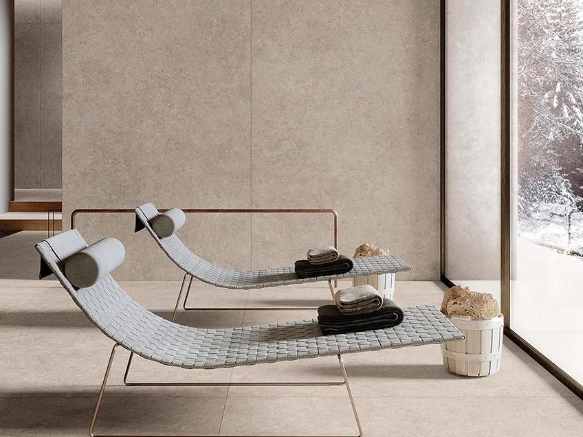 Modern sunroom featuring Palladium Ivory porcelain slabs on floor and walls with lounge chairs