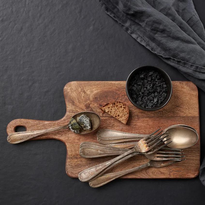 Langoustine and herb garnish in a bowl resting on the Pigalle porcelain slabs.