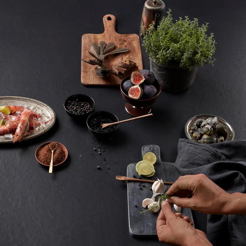 Overhead scene with prawns and bowls arranged by hand on Pigalle porcelain slabs.
