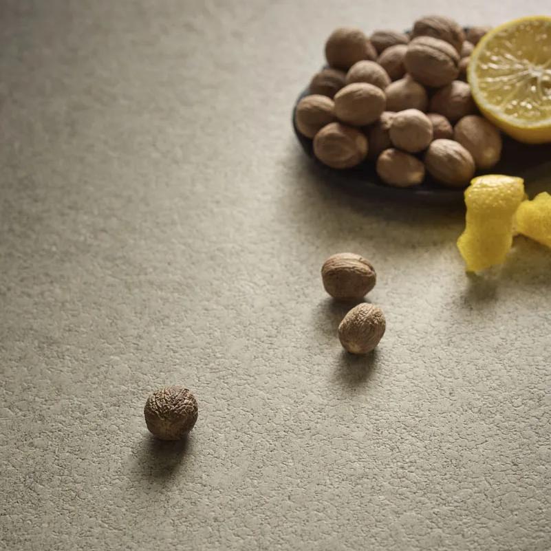 Provençale porcelain slabs surface with scattered acorns and peel of lemons in the corner