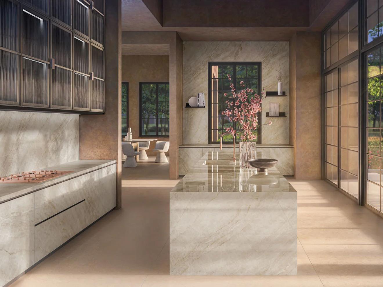Taj Mahal porcelain slabs used on kitchen island, flooring, and cabinetry in an open space