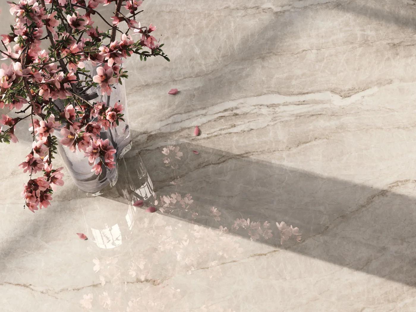 Pink floral arrangement placed on a smooth Taj Mahal porcelain slabs countertop surface