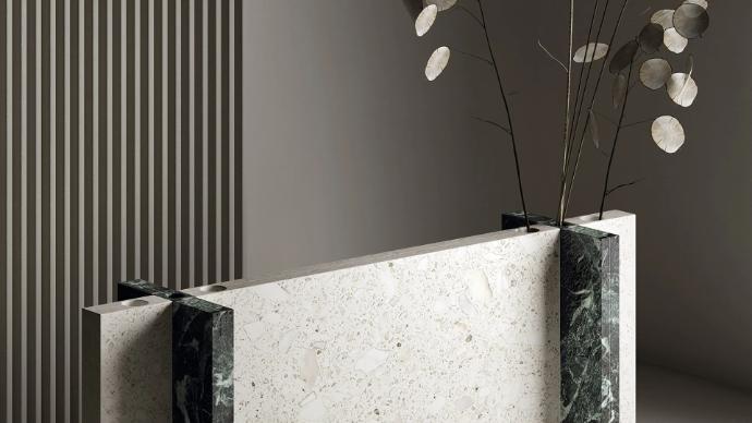 Terrazzo White porcelain slabs front desk paired with green stone accents and decorative branches