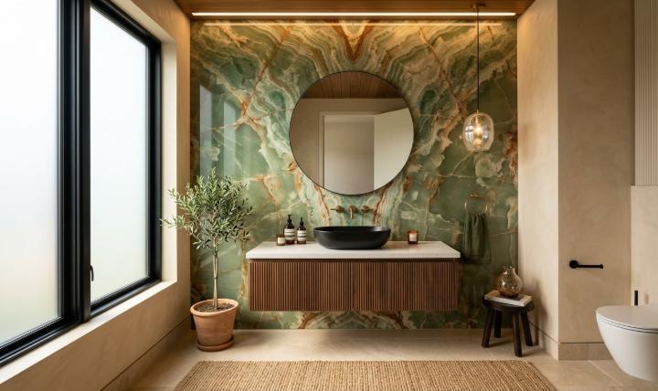 Green onyx accent wall panel in a contemporary powder room interior