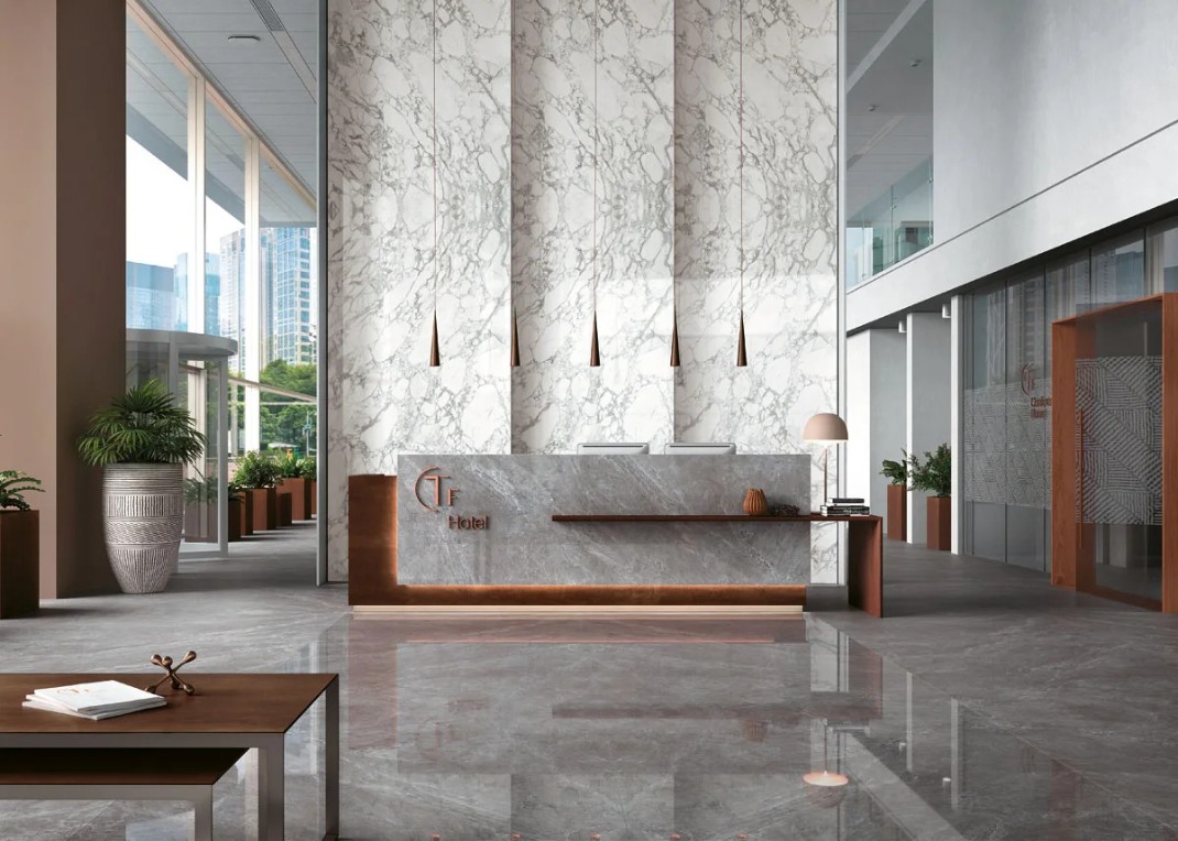 Tundra Select porcelain slabs used as a full-height wall cladding behind a hotel reception desk