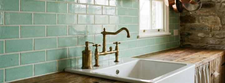 Green subway tile backsplash with horizontal brick pattern in rustic kitchen