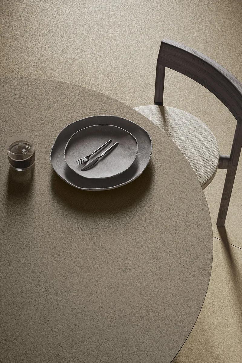 Plaster Sand porcelain slabs table surface with dining plate and chair overhead view